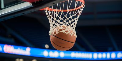 A basketball dropping through a hoop.