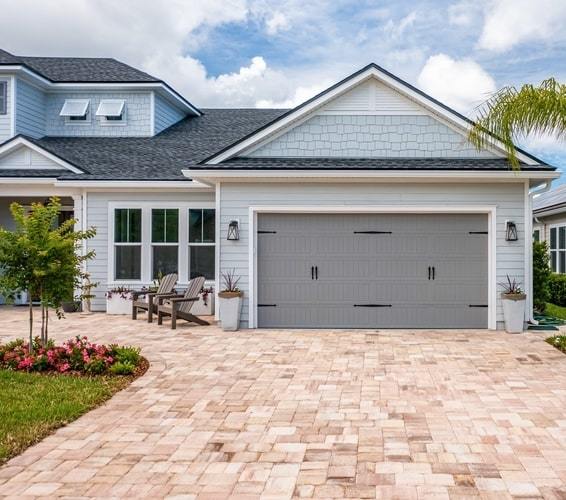 Exterior of Key West style home with brick driveway, typical of Royal Legacy Estates