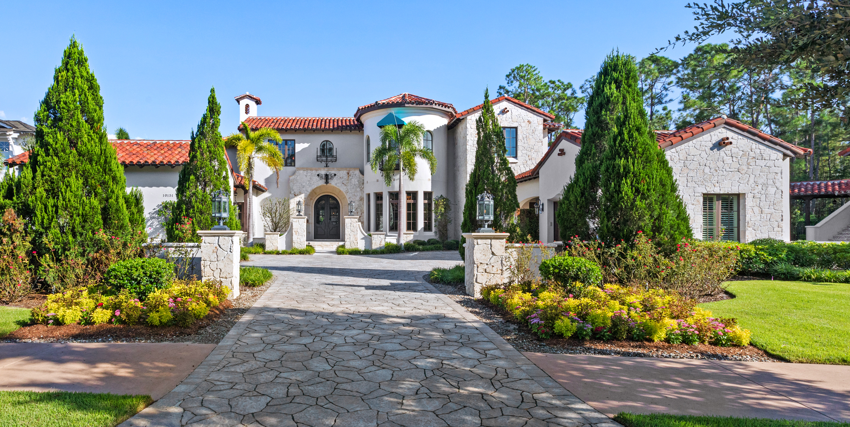 Exterior of a sprawling estate with a walkway and landscaping