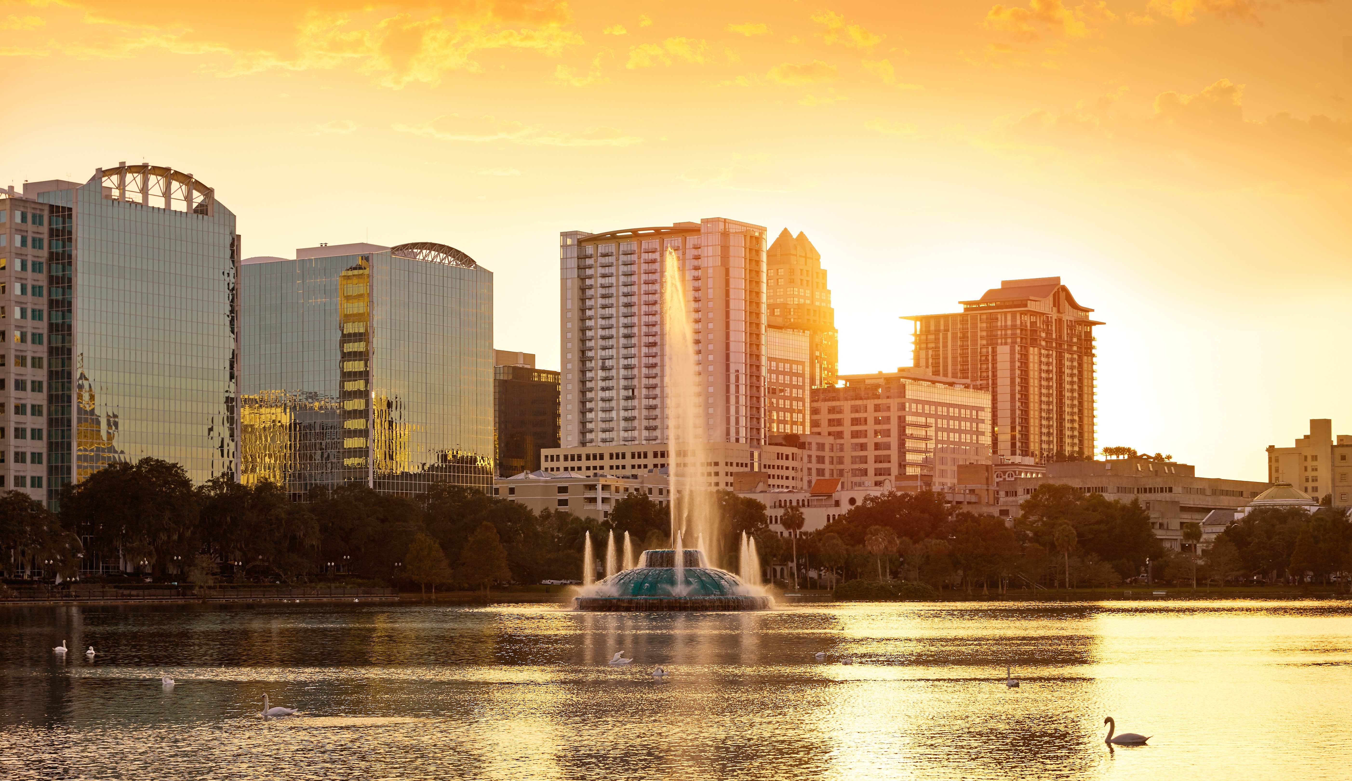 lake eola with golden sunset through buildings