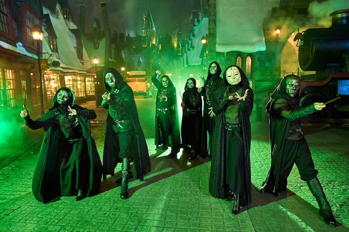 death eaters in hogsmeade with green lighting at night