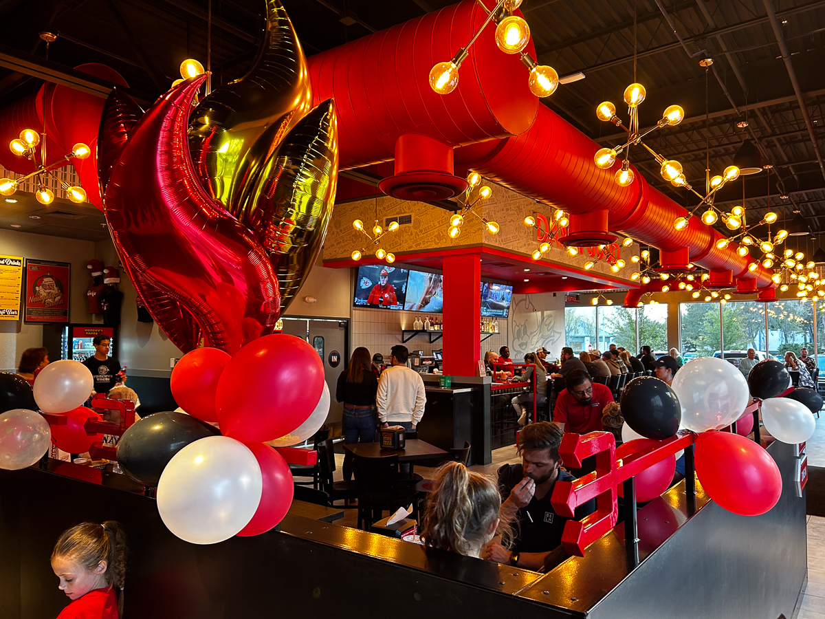 inside torchys restaurants with red fire balloons and red and black decor