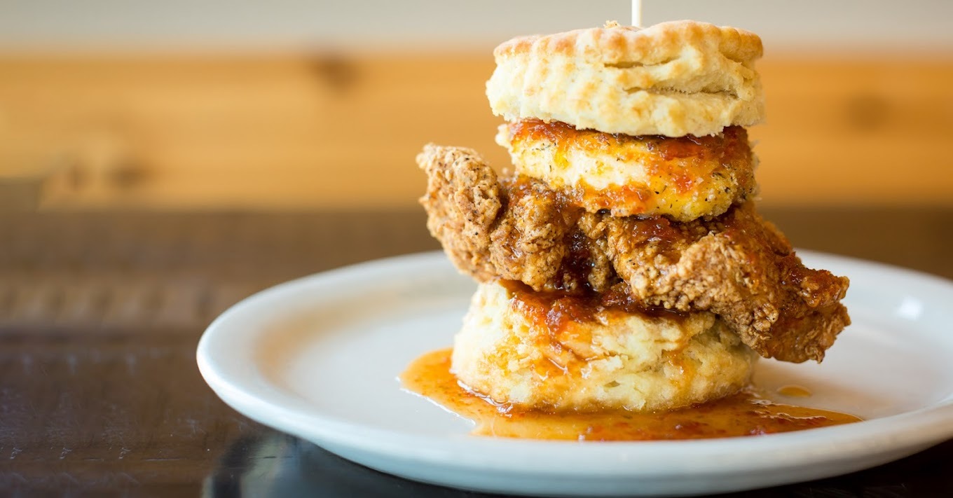 chicken biscuit with syrup on a white plate