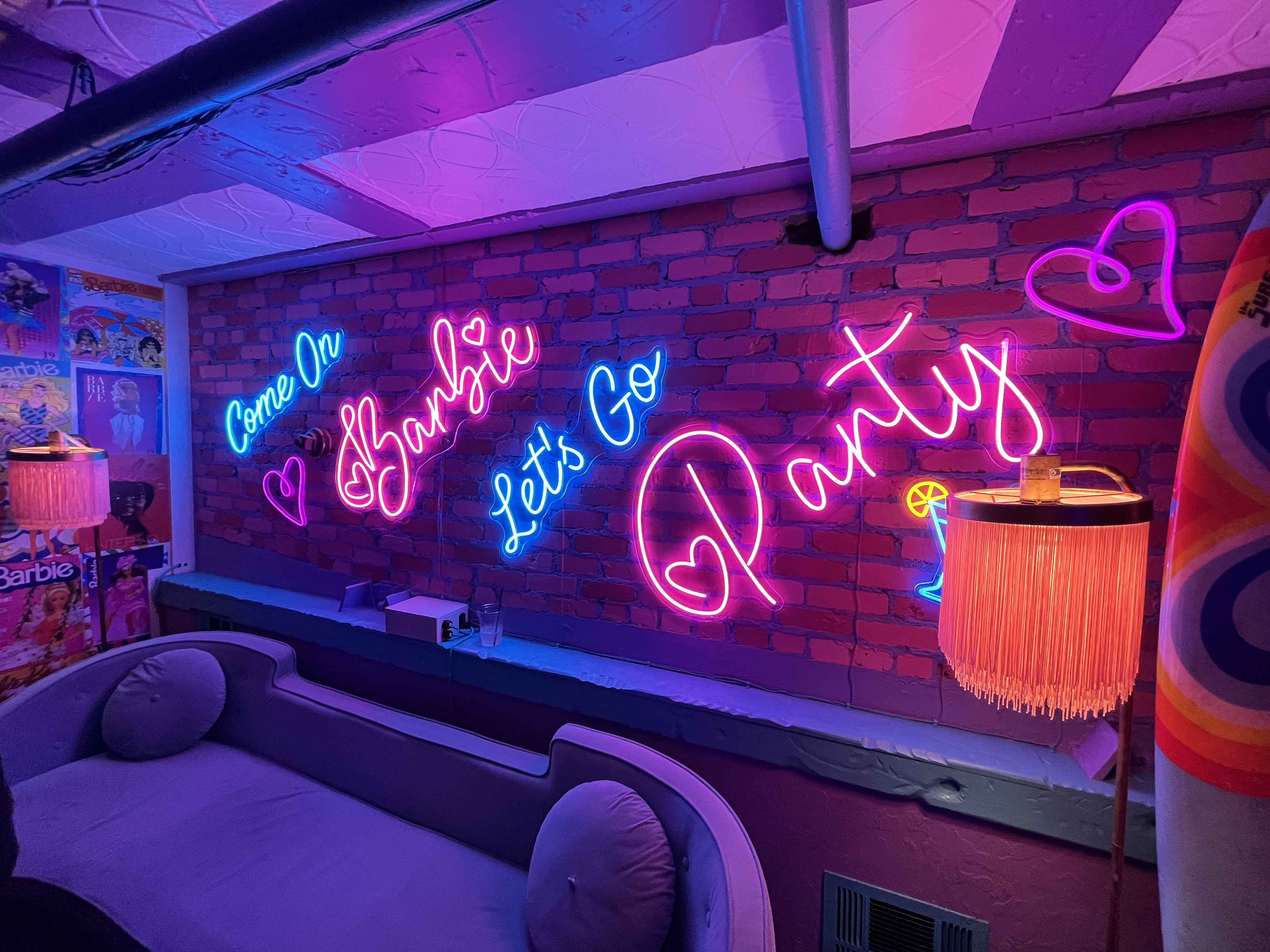 one up bar with neon barbie sign