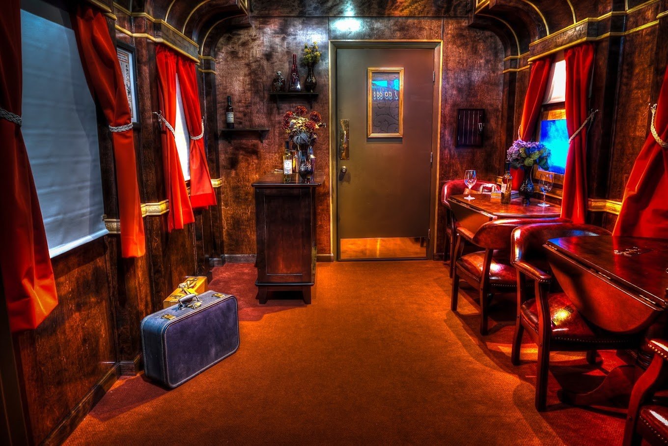 red room in escapology with curtains and train car decor
