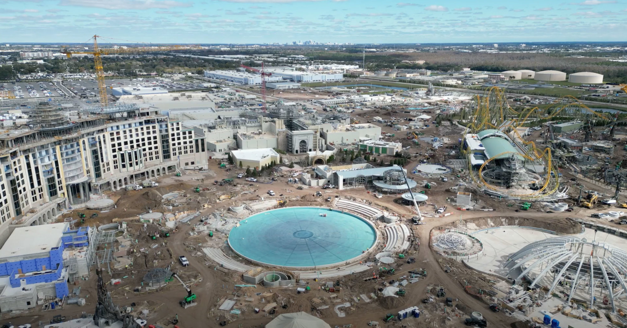 construction drone shot of hotel with circle water feature base in front of it