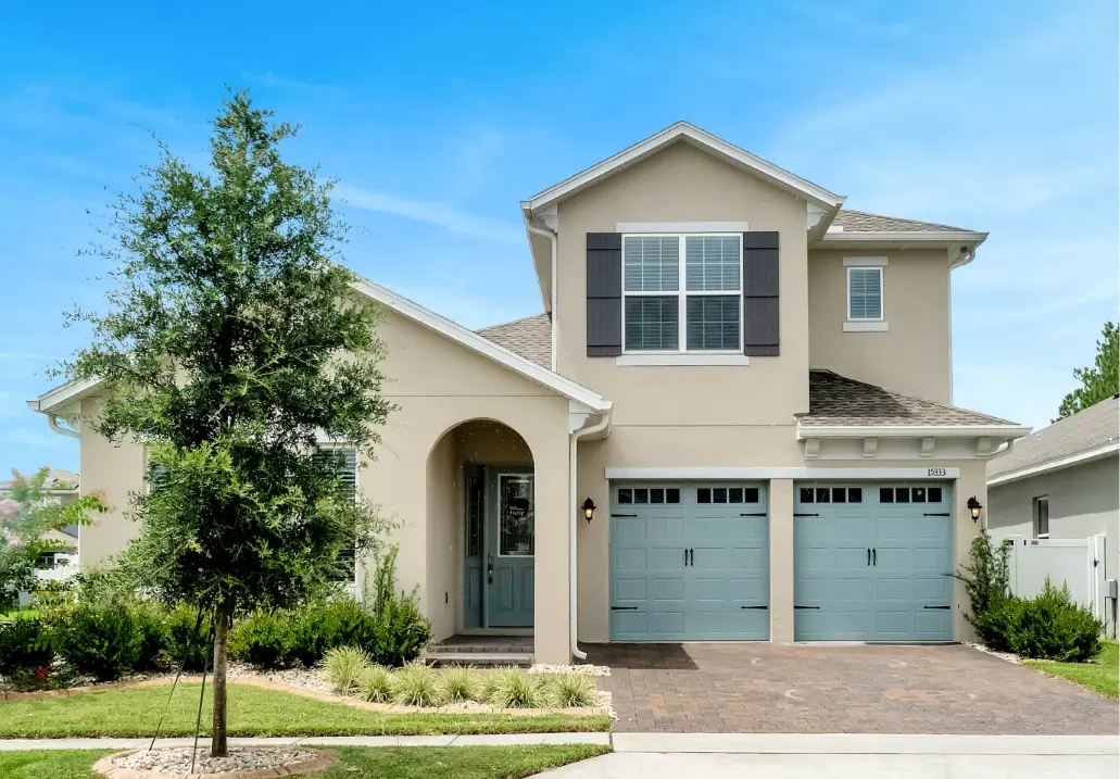 Beige house with tree in foreground
