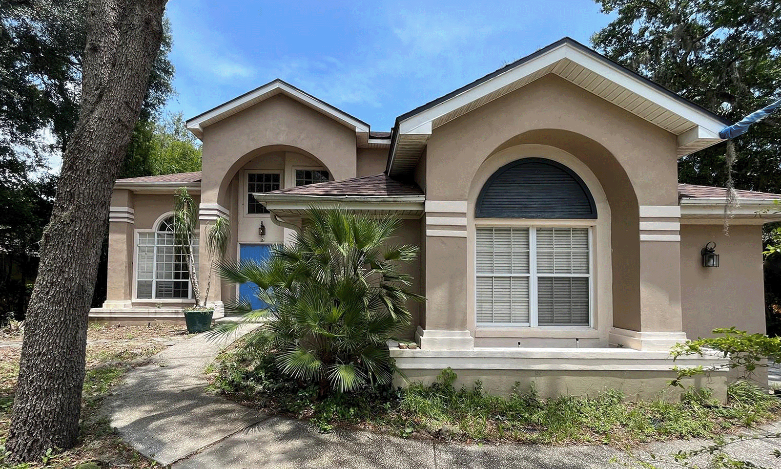 front of home with beige and white paint