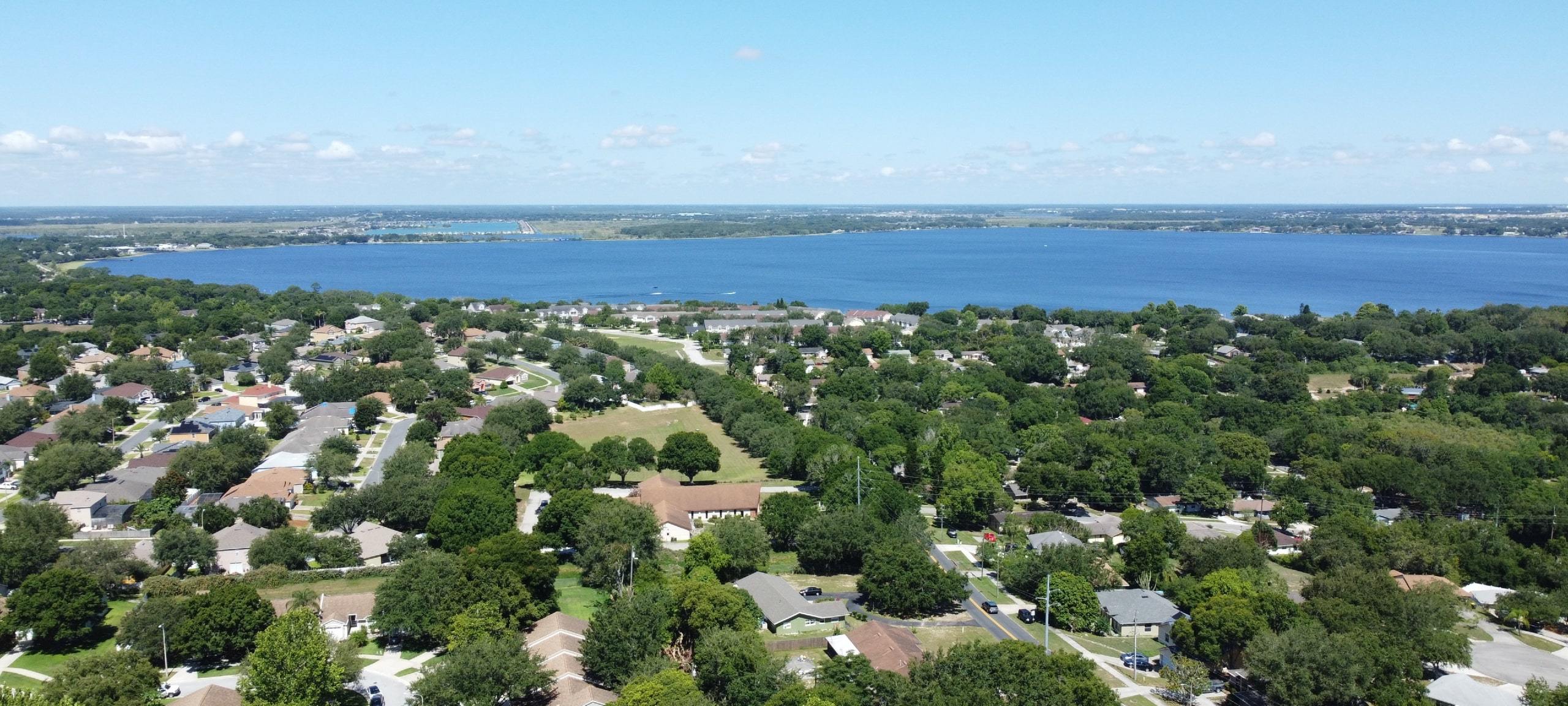 Aerial view over homes by the lakefront in Clermont, FL