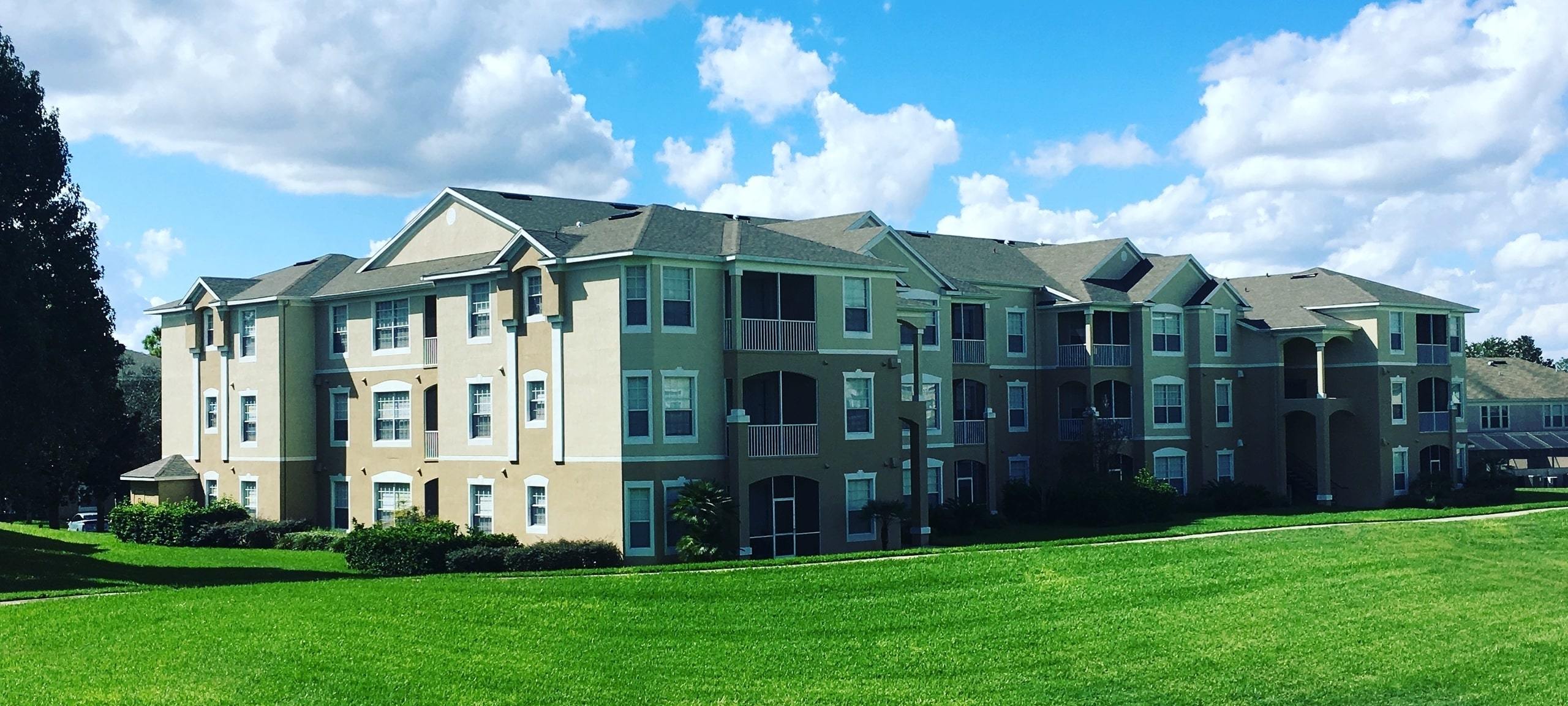 Mid-rise condo complex on green grass in Kissimmee, Florida