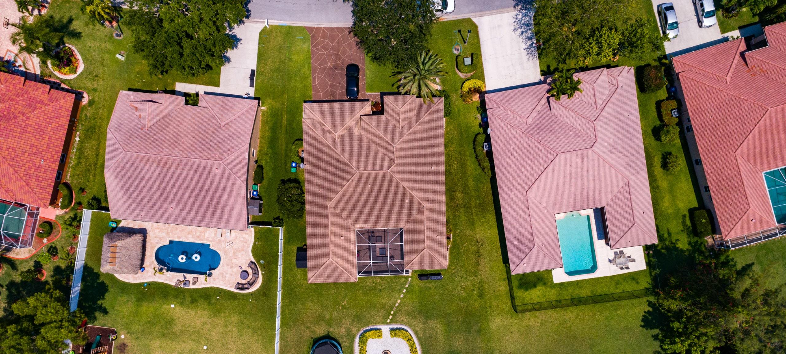 Aerial view of Mediterranean-style homes with backyard pools outside of Orlando, FL