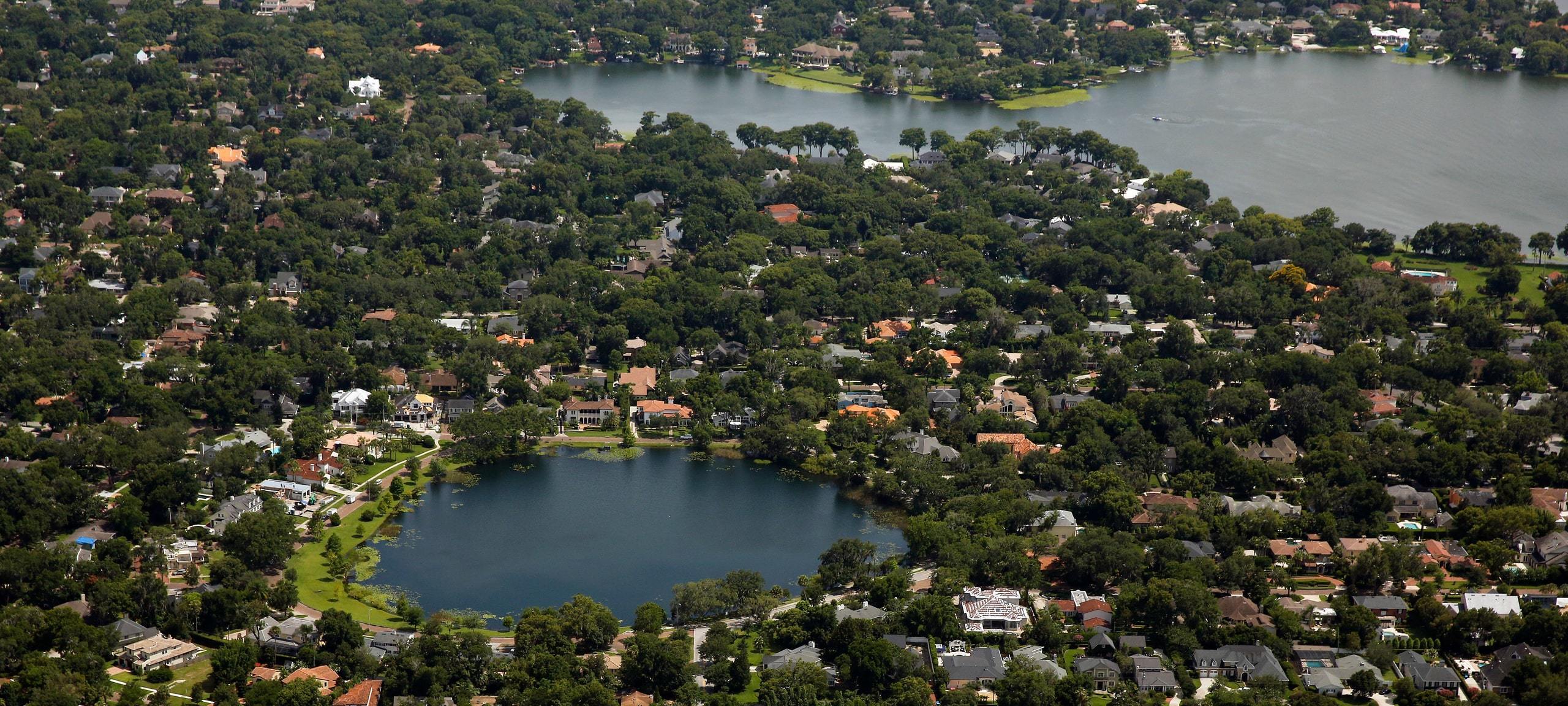 Aerial view over Maitland, FL with homes around lakes