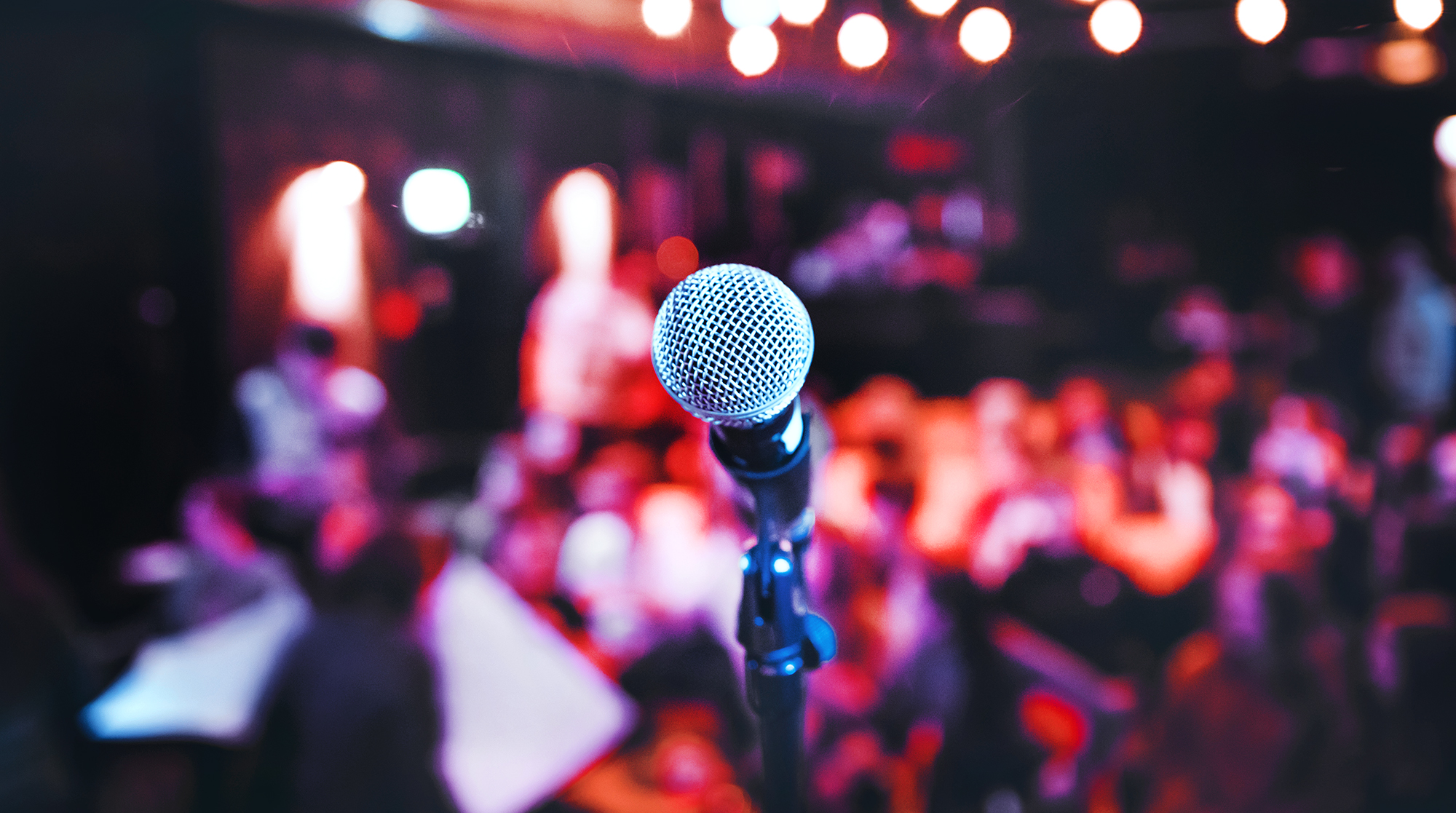 A microphone on a stage under spotlights.