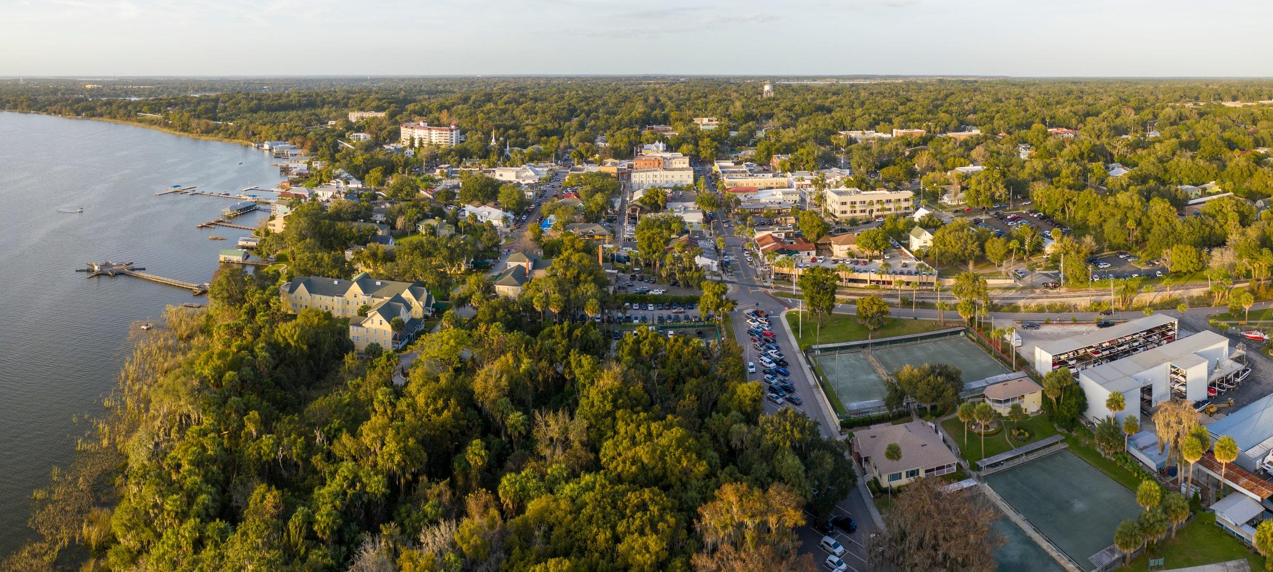 Aerial view over Mount Dora, FL waterfront and downtown area during sunset