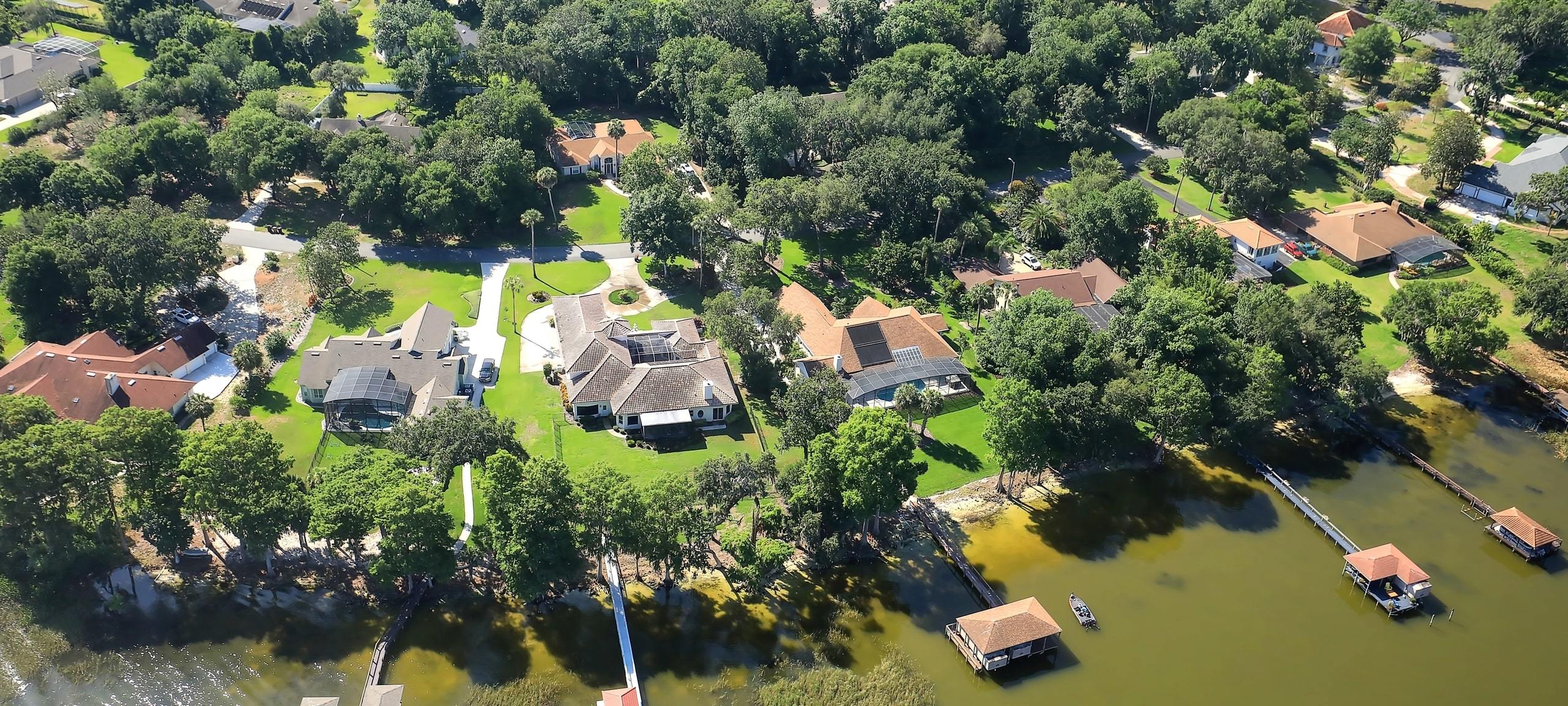 Aerial view over Mount Dora waterfront neighborhood, with private docks attached to homes