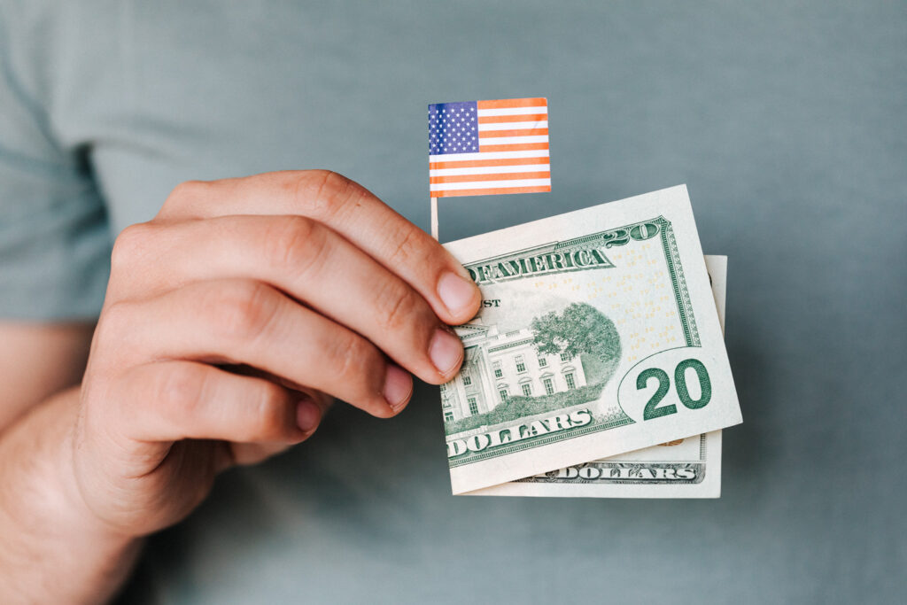 Man Holding Money and American Flag - Election