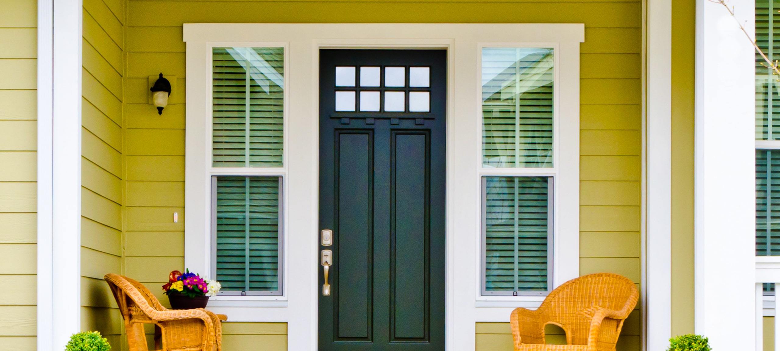 Entrance of yellow, Craftsman style home, typical of Thornton Park & Delaney Park, Orlando