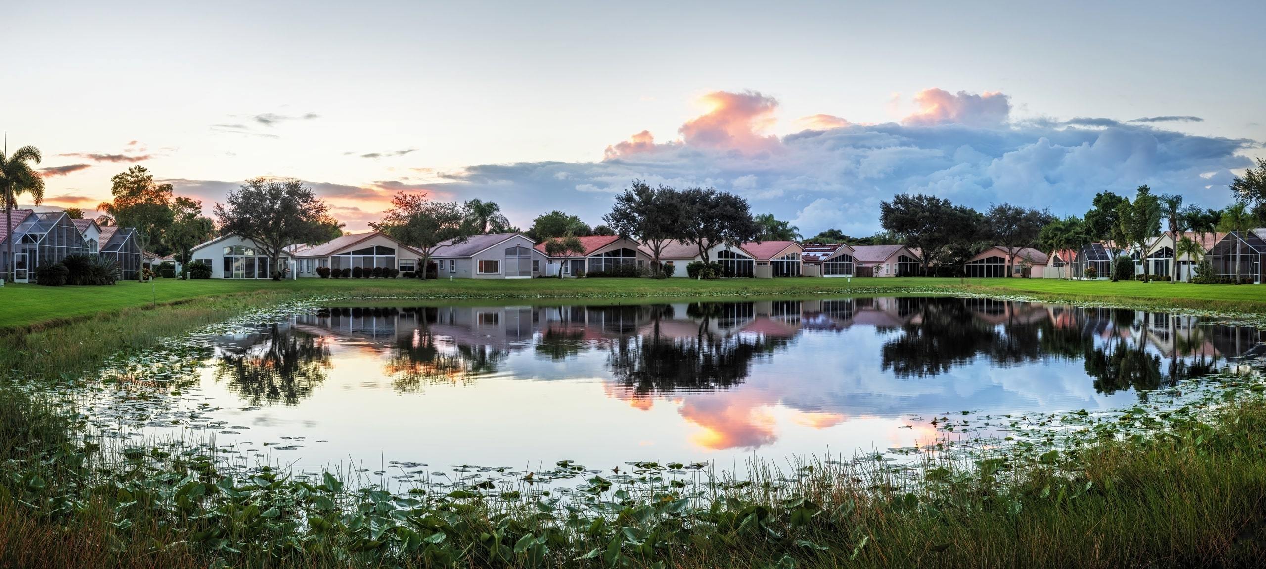 Sunset over golf homes on waterfront in Central Florida
